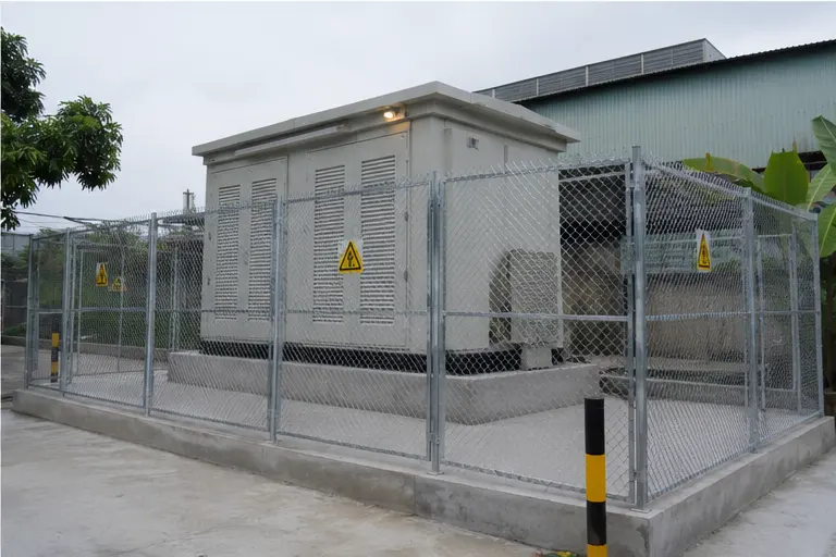 Fenced and completed compact prefabricated substation on an industrial site